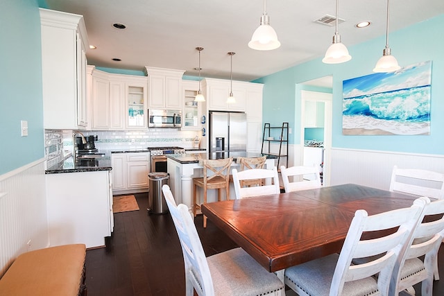 dining area with dark hardwood / wood-style floors and sink