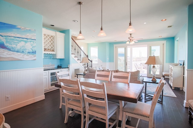 dining area with ceiling fan and dark wood-type flooring