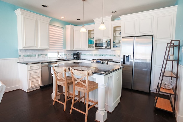 kitchen featuring a center island, tasteful backsplash, appliances with stainless steel finishes, dark hardwood / wood-style flooring, and sink