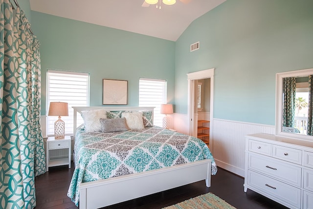 bedroom with connected bathroom, vaulted ceiling, ceiling fan, and dark hardwood / wood-style floors