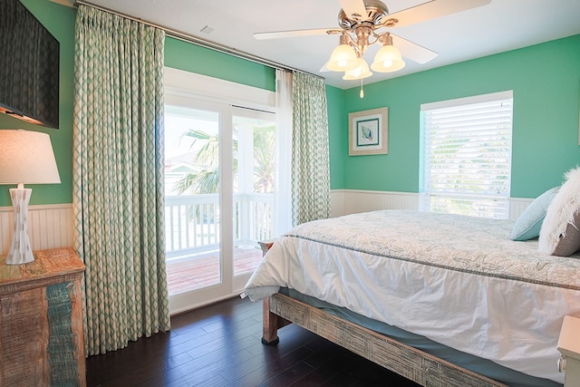 bedroom with ceiling fan, dark hardwood / wood-style floors, and access to outside