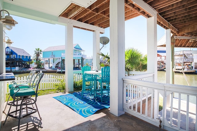 view of patio featuring a boat dock and a water view