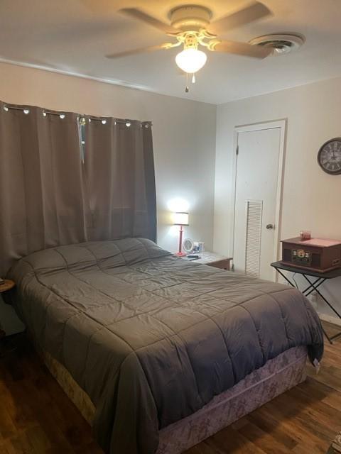 bedroom with hardwood / wood-style flooring and ceiling fan