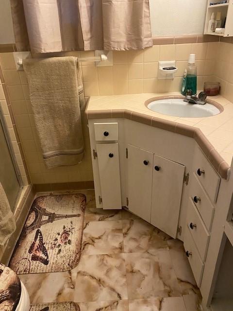 bathroom with vanity and walk in shower