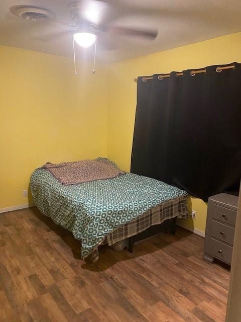 bedroom with wood-type flooring and ceiling fan