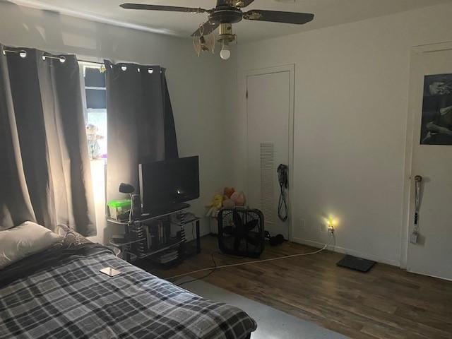 bedroom with ceiling fan and dark wood-type flooring