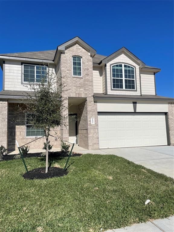 view of front of property with a front yard and a garage