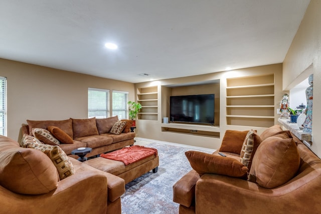 carpeted living room featuring built in features