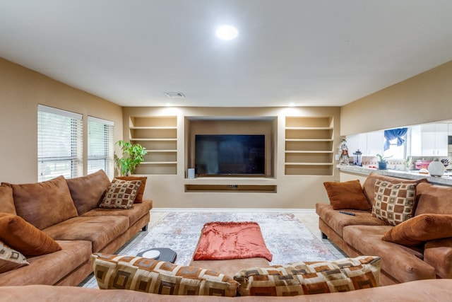 living room with built in features and plenty of natural light