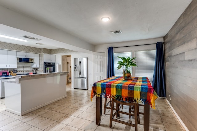 tiled dining area with wood walls