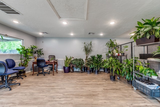 office space featuring a textured ceiling and light wood-type flooring