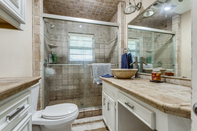 bathroom featuring walk in shower, toilet, and oversized vanity