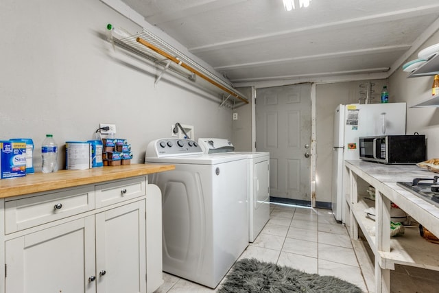 laundry area with light tile flooring, separate washer and dryer, and washer hookup