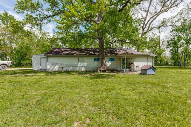 back of property featuring a yard