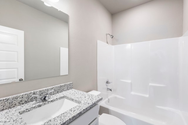 full bathroom featuring toilet, vanity, and tub / shower combination