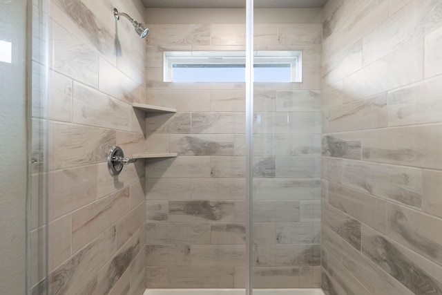 bathroom with a tile shower