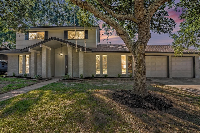 view of front of property with a yard and a garage