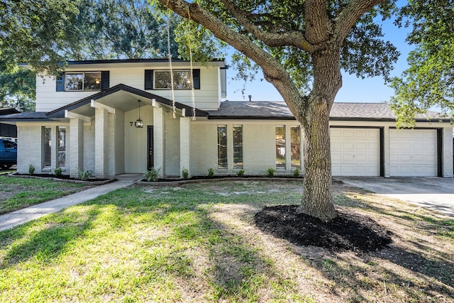 view of front facade with a front yard and a garage