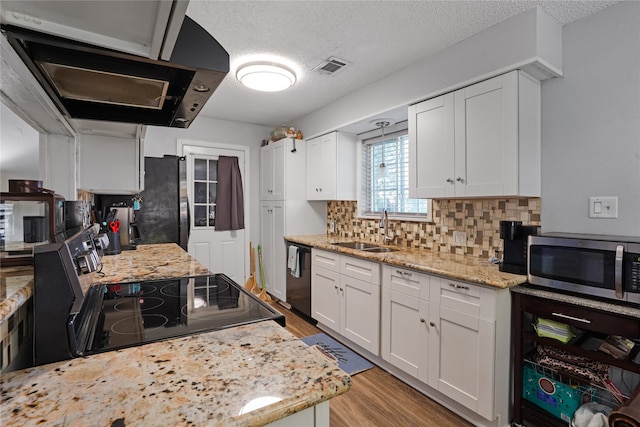 kitchen featuring tasteful backsplash, range, and white cabinets