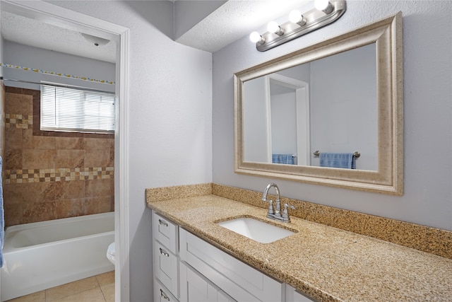 full bathroom with toilet, oversized vanity, a textured ceiling, tiled shower / bath, and tile flooring