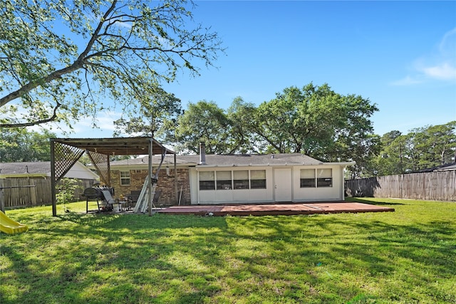 rear view of property featuring a deck, a pergola, and a yard