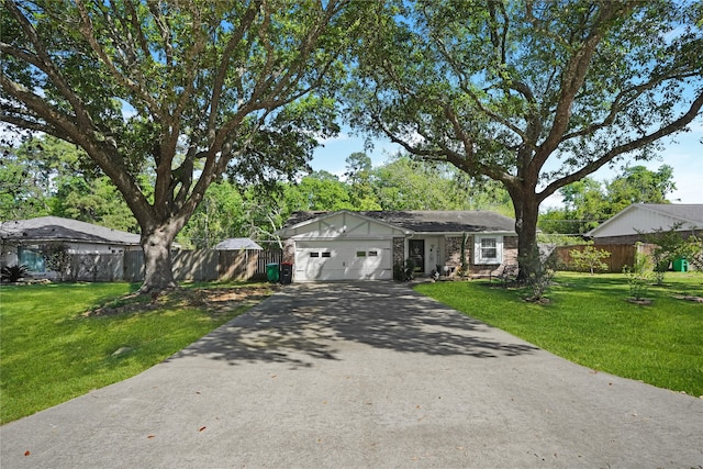 ranch-style house featuring a front yard and a garage