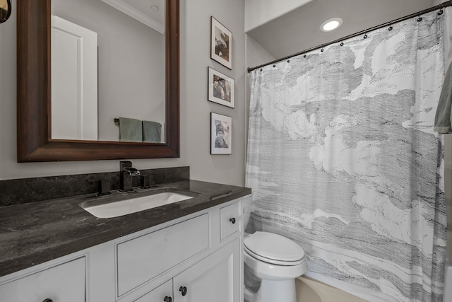 bathroom with vanity, toilet, and crown molding