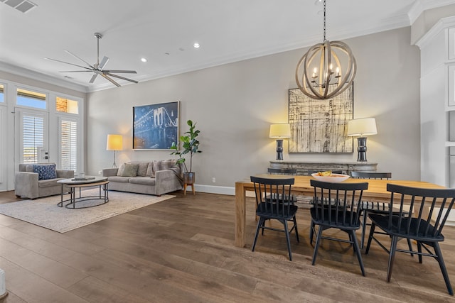 dining room featuring crown molding, ceiling fan with notable chandelier, and dark hardwood / wood-style floors