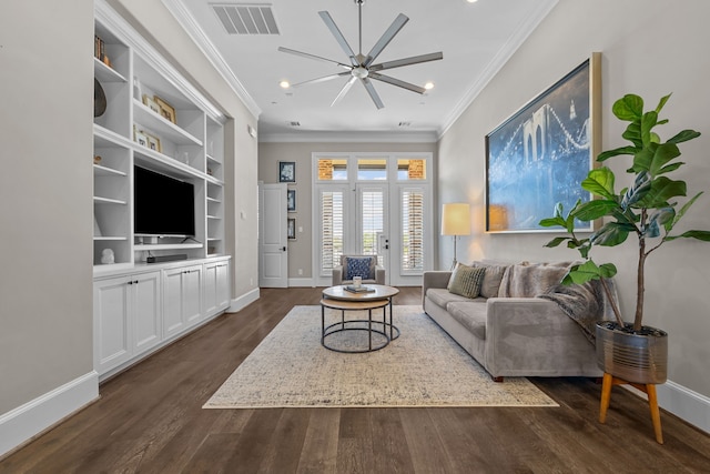 living room with built in shelves, dark hardwood / wood-style flooring, and ornamental molding