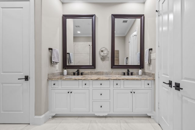 bathroom featuring vanity and ornamental molding