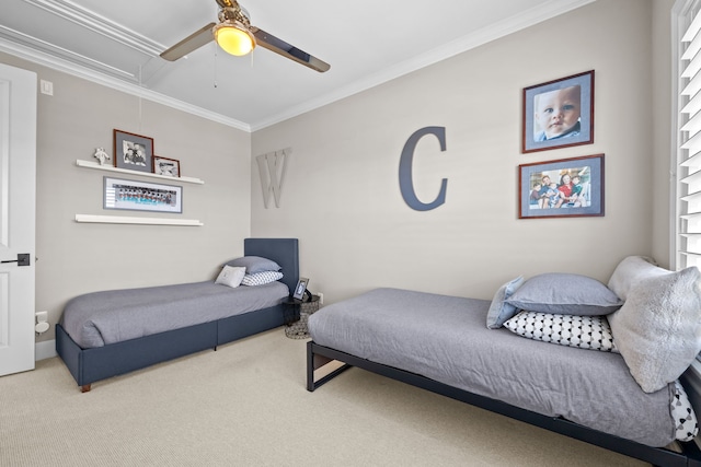 bedroom with ceiling fan, crown molding, and carpet flooring