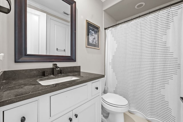 bathroom featuring vanity, toilet, and walk in shower