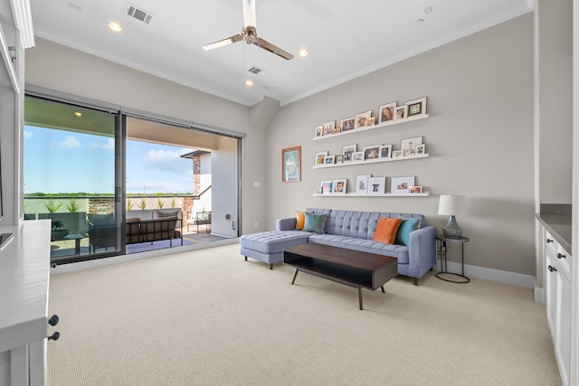 carpeted living room featuring crown molding and ceiling fan