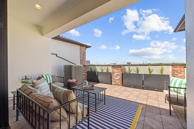 view of patio with an outdoor living space and a balcony