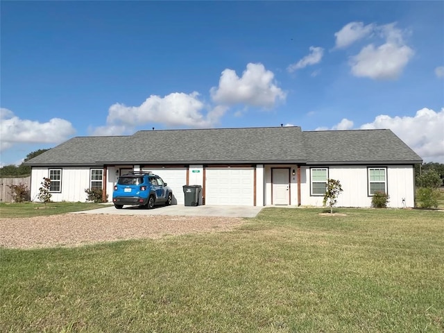 back of house featuring a yard and a garage