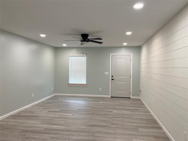 empty room with ceiling fan and light wood-type flooring