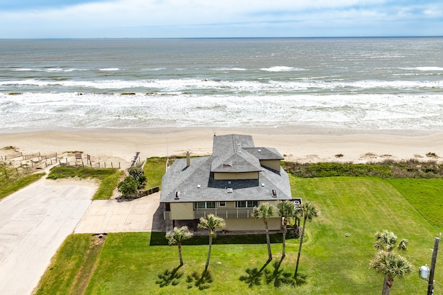 drone / aerial view featuring a water view and a view of the beach