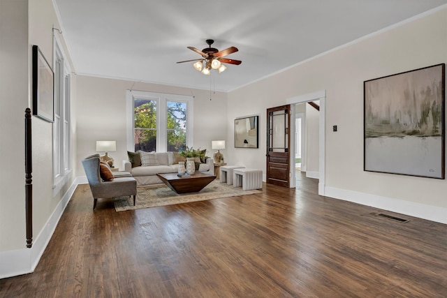 unfurnished living room with dark hardwood / wood-style flooring, ceiling fan, and ornamental molding