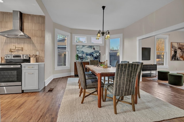 dining room featuring a notable chandelier and light wood-type flooring