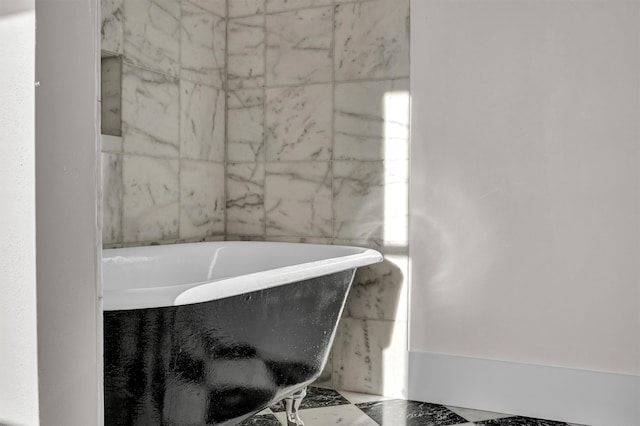 bathroom with a bath and tile flooring