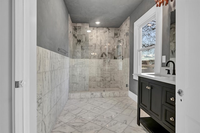 bathroom with vanity, tiled shower, and tile flooring