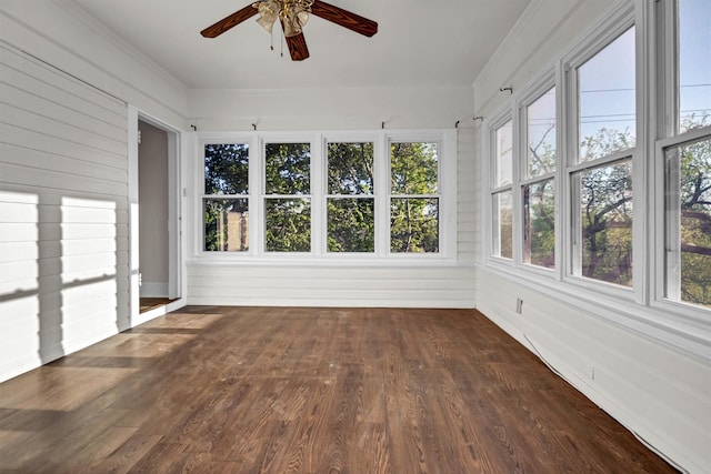 unfurnished sunroom featuring ceiling fan