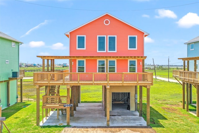 back of house with a wooden deck and a lawn