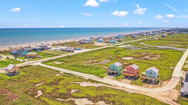 bird's eye view featuring a water view and a beach view