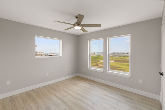 unfurnished room with light wood-type flooring and ceiling fan