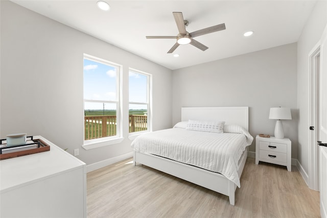 bedroom featuring light hardwood / wood-style flooring and ceiling fan