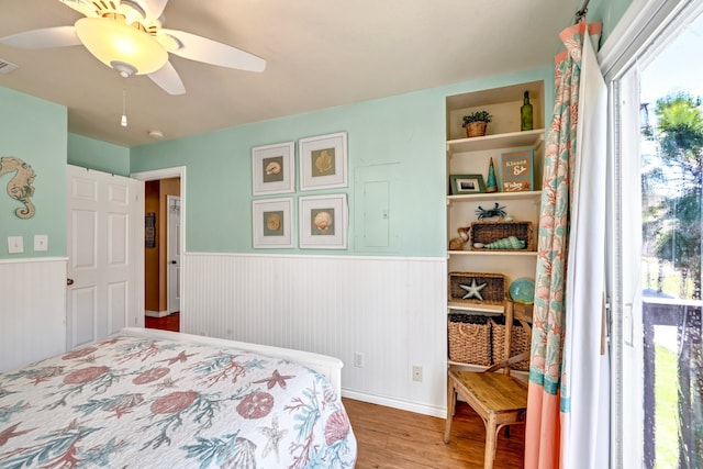 bedroom with ceiling fan and hardwood / wood-style flooring