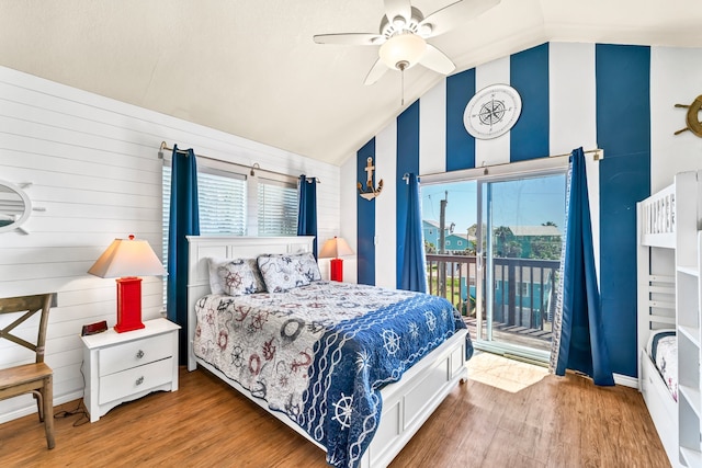 bedroom with multiple windows, vaulted ceiling, and light hardwood / wood-style flooring