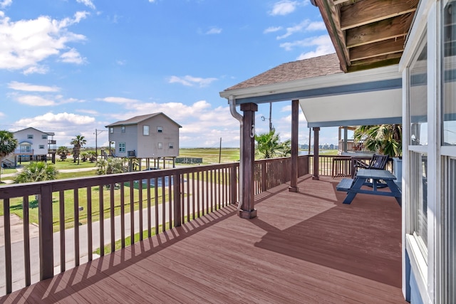 wooden terrace with a lawn