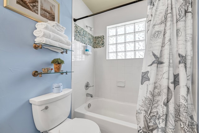 bathroom featuring shower / bath combo and toilet